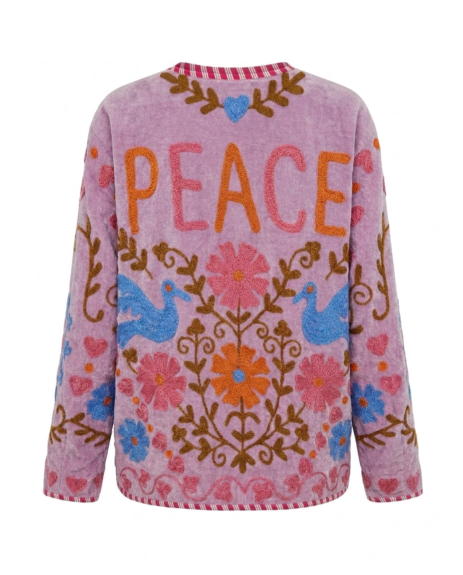 Dos de la veste en velours lilas Cofur, le mot PEACE brodé en orange et rose entre deux colombes bleues