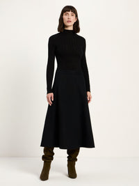 Jupe midi évasée en flanelle de laine et coton bio LANIUS Noir – vue de face, avec un col roulé noir et des bottes souples