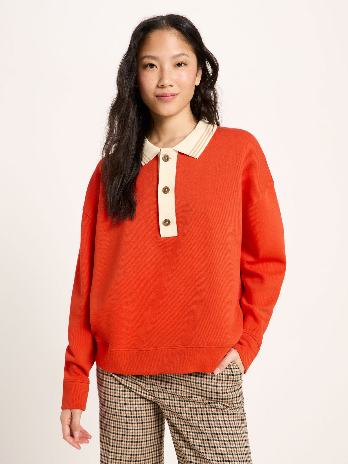 Sweat col polo coton bio LANIUS Rouge feu porté avec un pantalon à carreaux – vue de face